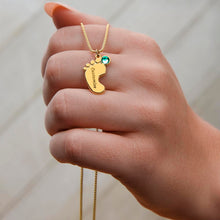 Load image into Gallery viewer, Hand holding gold footprint necklace with birthstone